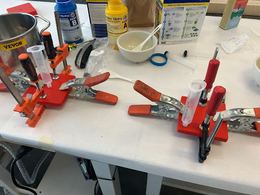 Silicone injection setup with luer syringe and clamps
